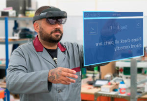Manufacturing human worker clicks on next task on a blue rectangle that displays augmented reality instructions