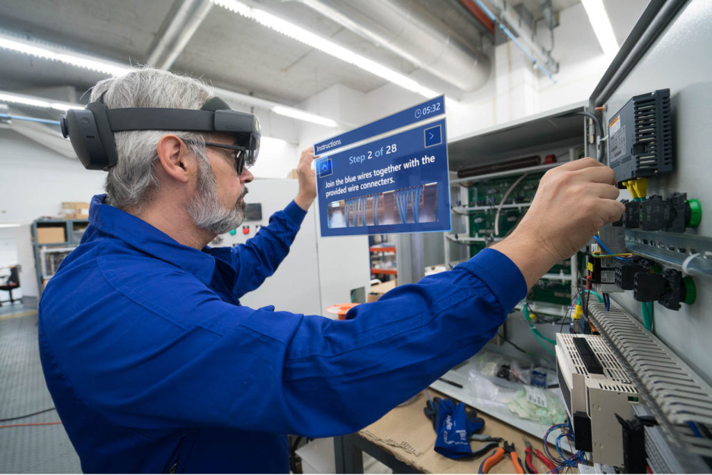 Manufacturing human worker sees the next steps to his task on a blue rectangle that displays augmented reality instructions 