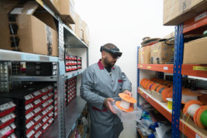 Male manufacturing worker on the warehouse, holding an object due to the packing product from KIT-AR