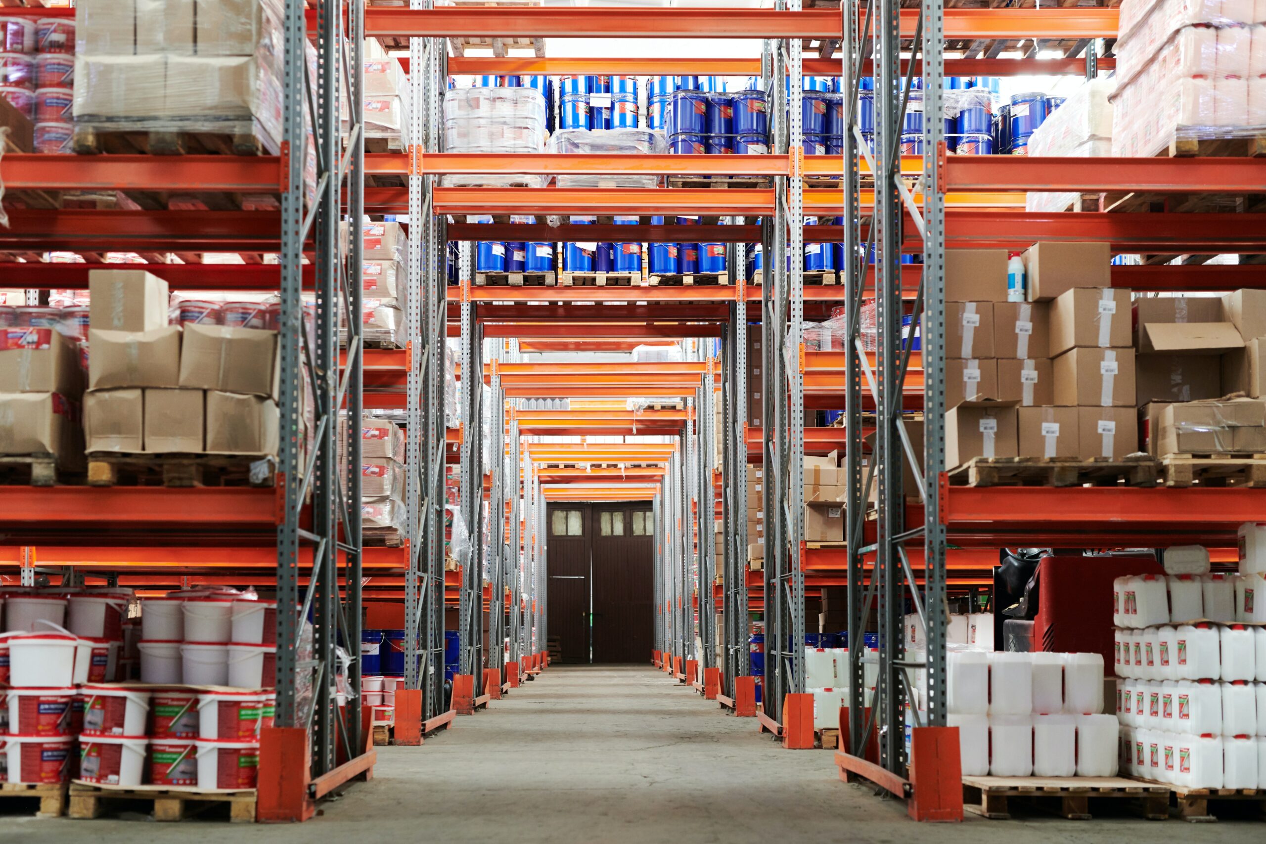 Big manufacturing warehouse with many packages divided into two rows 