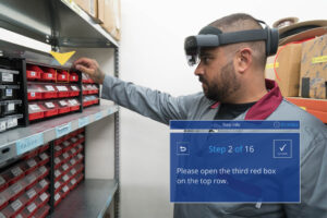 Kitting & Packing: Warehouse background with one worker who has smartglasses on which are indicating the next step to follow.