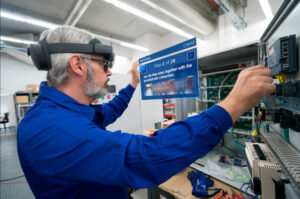 Manufacturing human worker sees the next steps to his task on a blue rectangle that displays augmented reality instructions